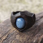 The pendant is made of bog oak with turquoise