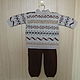 Kit for a baby from warm woolen yarn consists of a semi-overall and sweater.