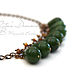 Chain necklace with a gorgeous large jade rich color of green grass complemented by small faceted brownish yellow crystals with a Sunny amber sheen.
