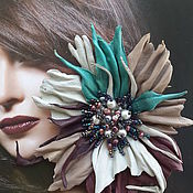 The colors of the skin. Brooch made of leather. 