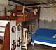 Loft bed in a marine style with decorative elements in the form of an anchor, helm, rope. It will be appreciated by little adventurers.