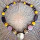 Necklace in the ethnic African style with natural stones and wooden beads exotic tree species. Creative decoration natural yellow and brown colors.