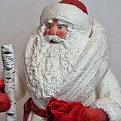 Santa Claus with bullfinches toy under the Christmas tree as a child made of cotton wool