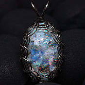 Artifact. Pendant glass flask with wood made of opal crystals and moss