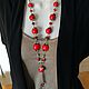 A long red piece of coral, an unusual stylish red coral decoration necklace Long original red beads, Elegant jewelry for women. Red decoration from natural stones.
