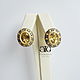 Large gold earrings with the purest beryls and sapphires.
