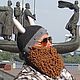 Photo. Knitted hat Helmet Viking with a beard and horns.