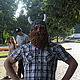 Photo. Knitted hat Helmet Viking with a beard and horns.