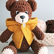 Teddy bear in overalls, knitted soft toy