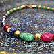 Short necklace of natural Indian rubies, emeralds and sapphires with brass beads and accessories will give its owner a piece of India with its rich traditional colors.

