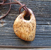 The pendant is made of birch burl