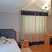 Gold curtains with a bedspread and pillows for the bedroom