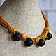 a small light necklace with a large porous black lava beads on a linen thread-mustard color - bright and stylish decoration for the summer.
