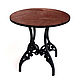 Wooden round table with openwork `forged` base.
