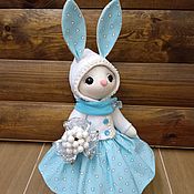 Toy hare in a blue dress