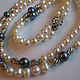 A set of pearl jewelry - necklace in two rows and bracelet. Black and white pearls, metal fittings.  
