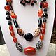 A set of jewelry from natural stones in the Eastern and African style of Zambia. Black and orange color scheme. Spectacular , stylish, exotic decoration.
